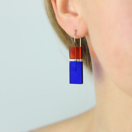 Short Construction earrings orange and blue worn