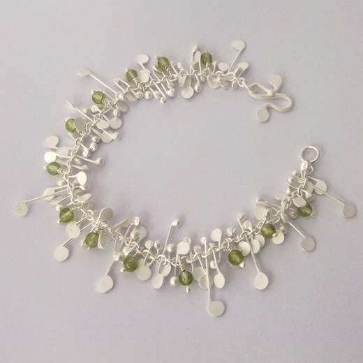 Blossom wire bracelet with peridot, satin by Fiona DeMarco