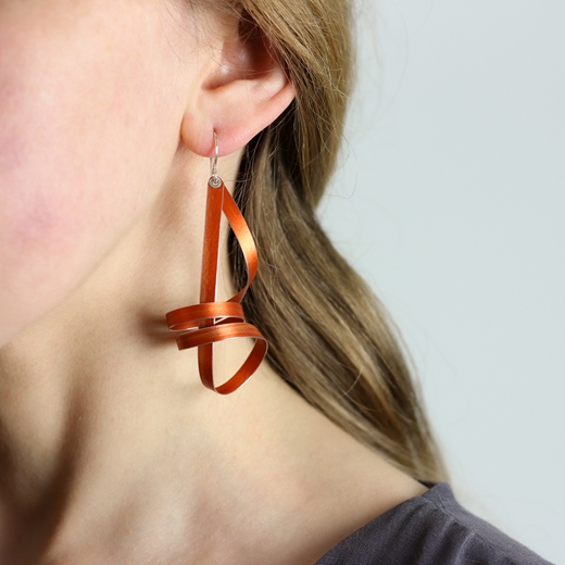 Orange long ribbon drop earrings worn