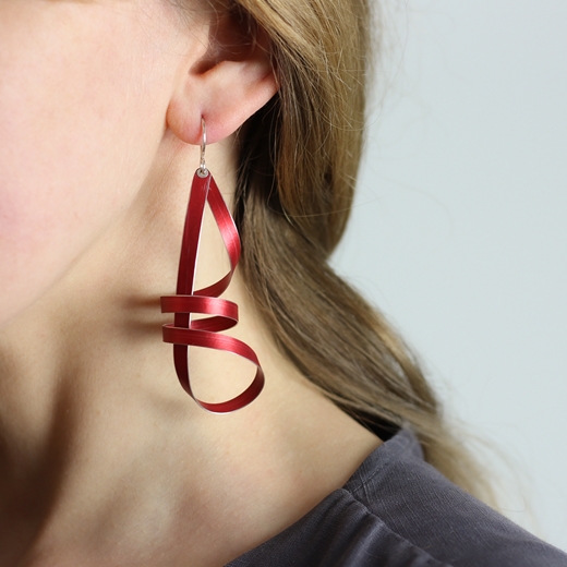 Red long ribbon drop earrings worn
