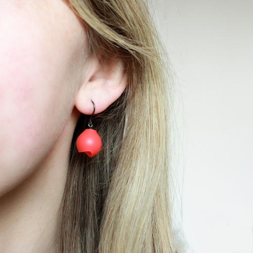 Fluoro red/orange silicone drop earrings worn