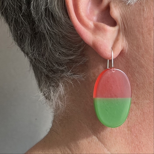Long split oval resin earrings worn