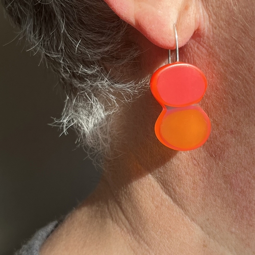 orange oval resin earrings worn
