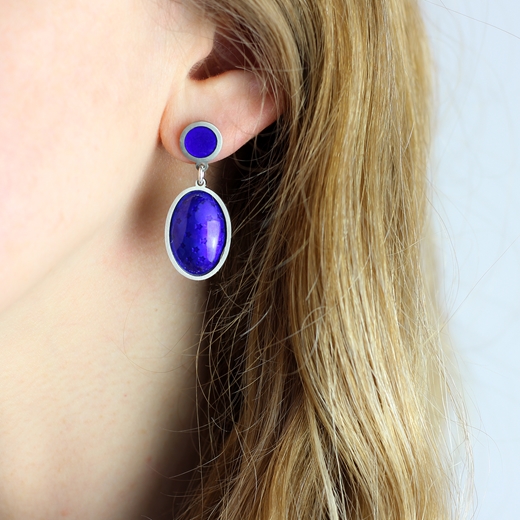 Blue enamel oval star earrings worn