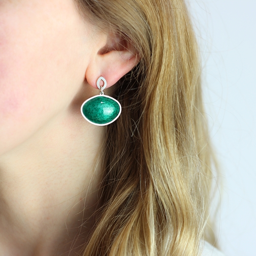 Green enamel leaf earrings worn