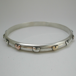 Bangle with silver, brass and 9ct rose gold hearts
