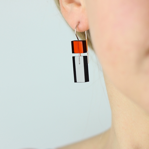 Short Construction earrings orange and grey worn