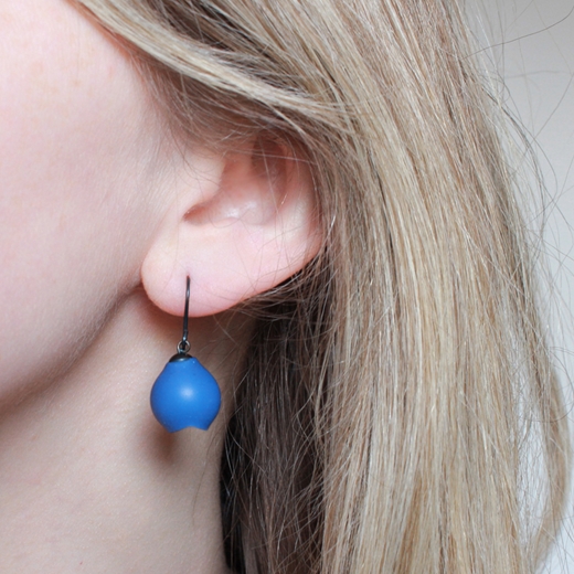 Blue drop earrings worn