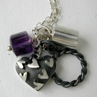 Heart on heart pendant with amethyst