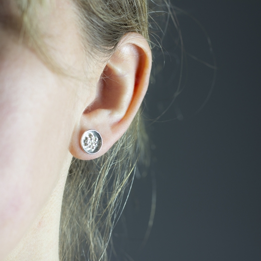 silver granulated earrings worn