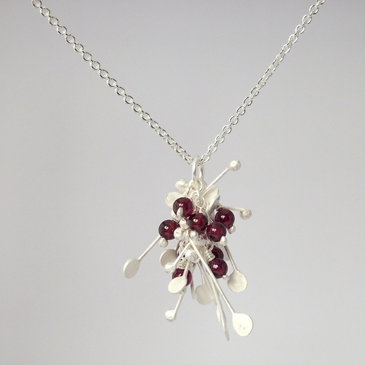 Blossom wire cluster pendant with garnet, satin by Fiona DeMarco