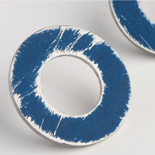 Close-up of small Dark Blue washer earrings