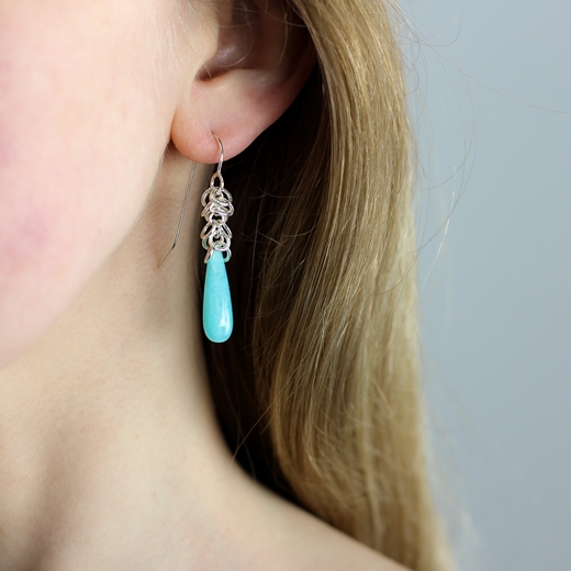 Flutter hoop earrings with amazonite beads worn