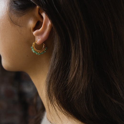 Emerald hoop earrings modelled