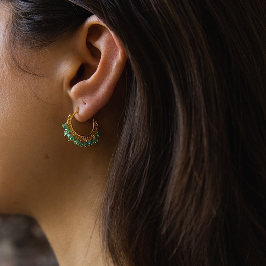 Emerald hoop earrings modelled