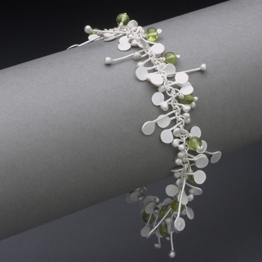 Blossom wire bracelet with peridot, satin