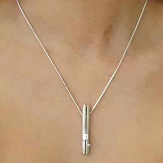 Long split silver pendant with diamond