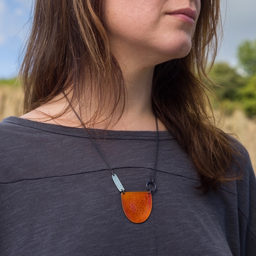 Tidal necklace in orange on model