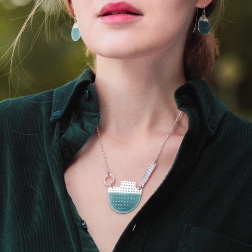 Island necklace and earrings on model