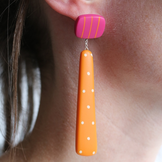 Long drop orange resin mismatch earrings worn