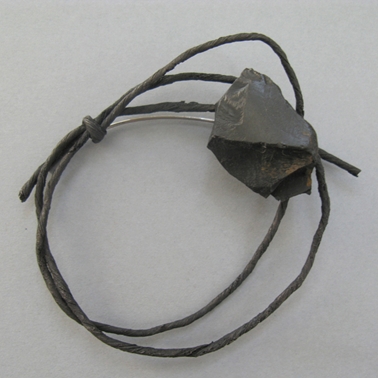 string brooch with jet