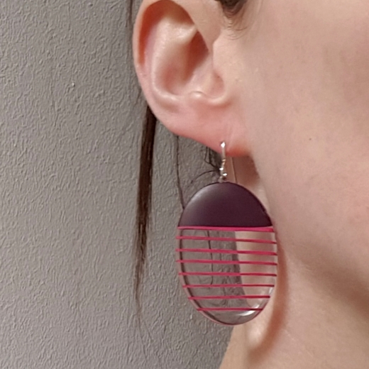 maroon oval resin earrings being modelled
