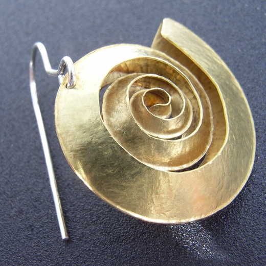 Close-up swirl brass earring