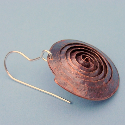 Close-up spiral copper earring