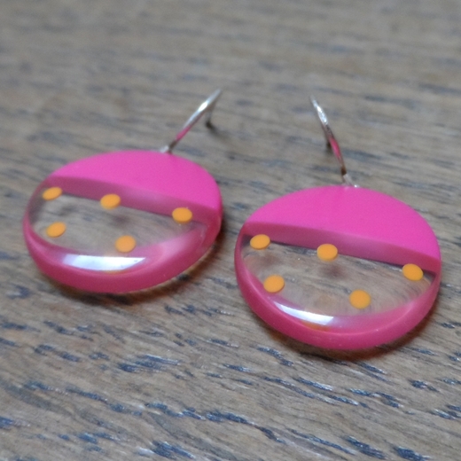 detail cerise round resin earrings with spotty pattern