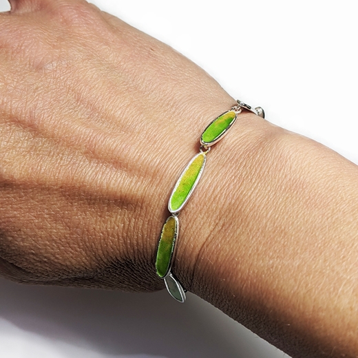 Slinky green and amber bracelet worn